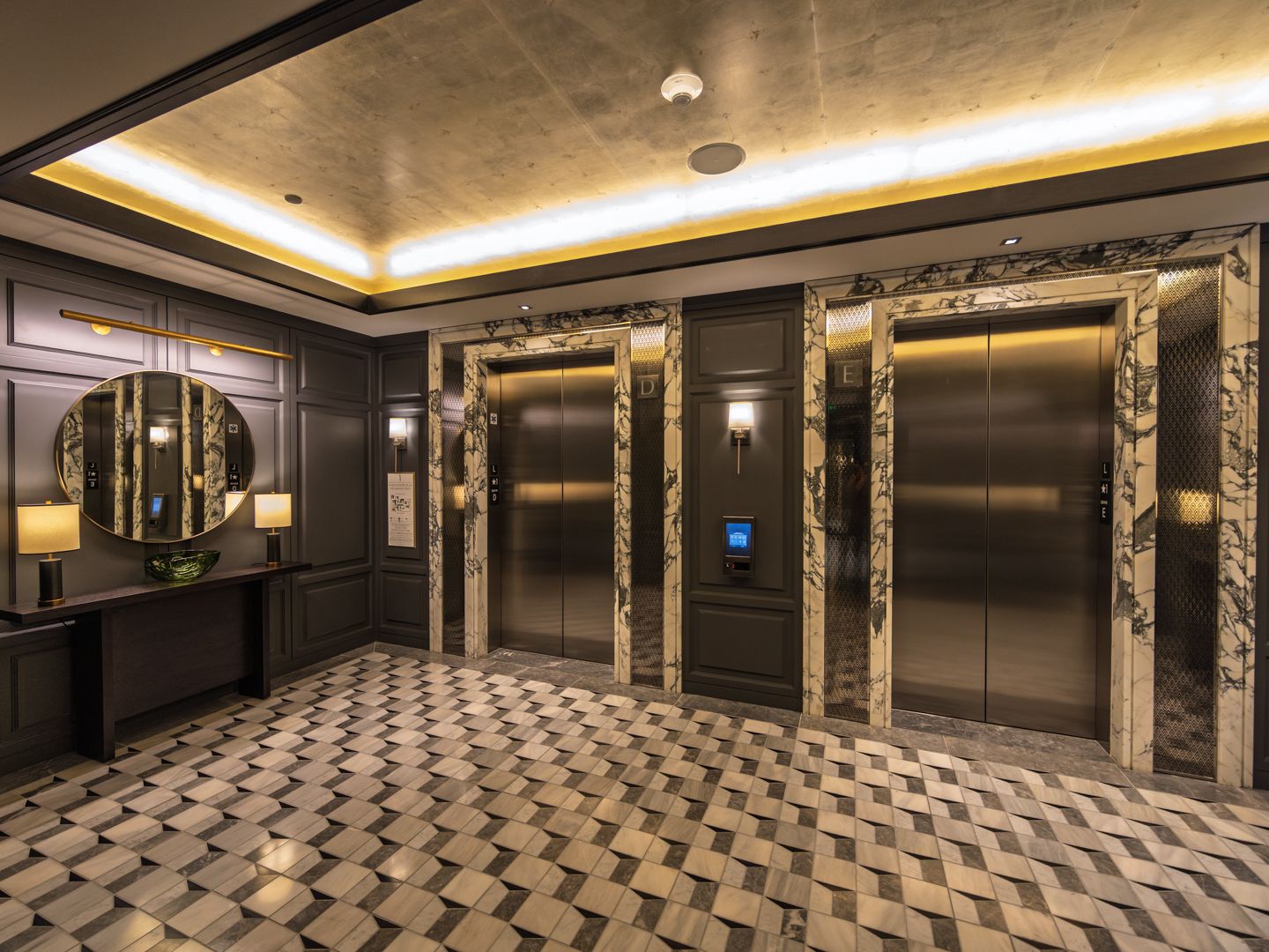 Residential elevator lobby with paneled walls at 706 Mission