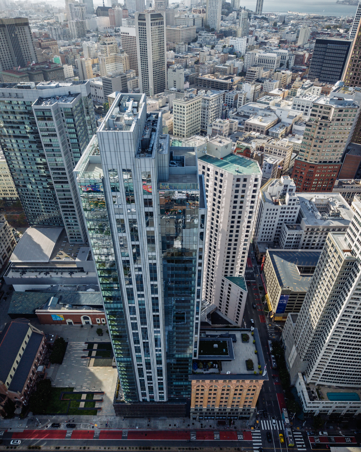 Daytime aerial view looking down the 706 Mission glass tower toward the Financial District