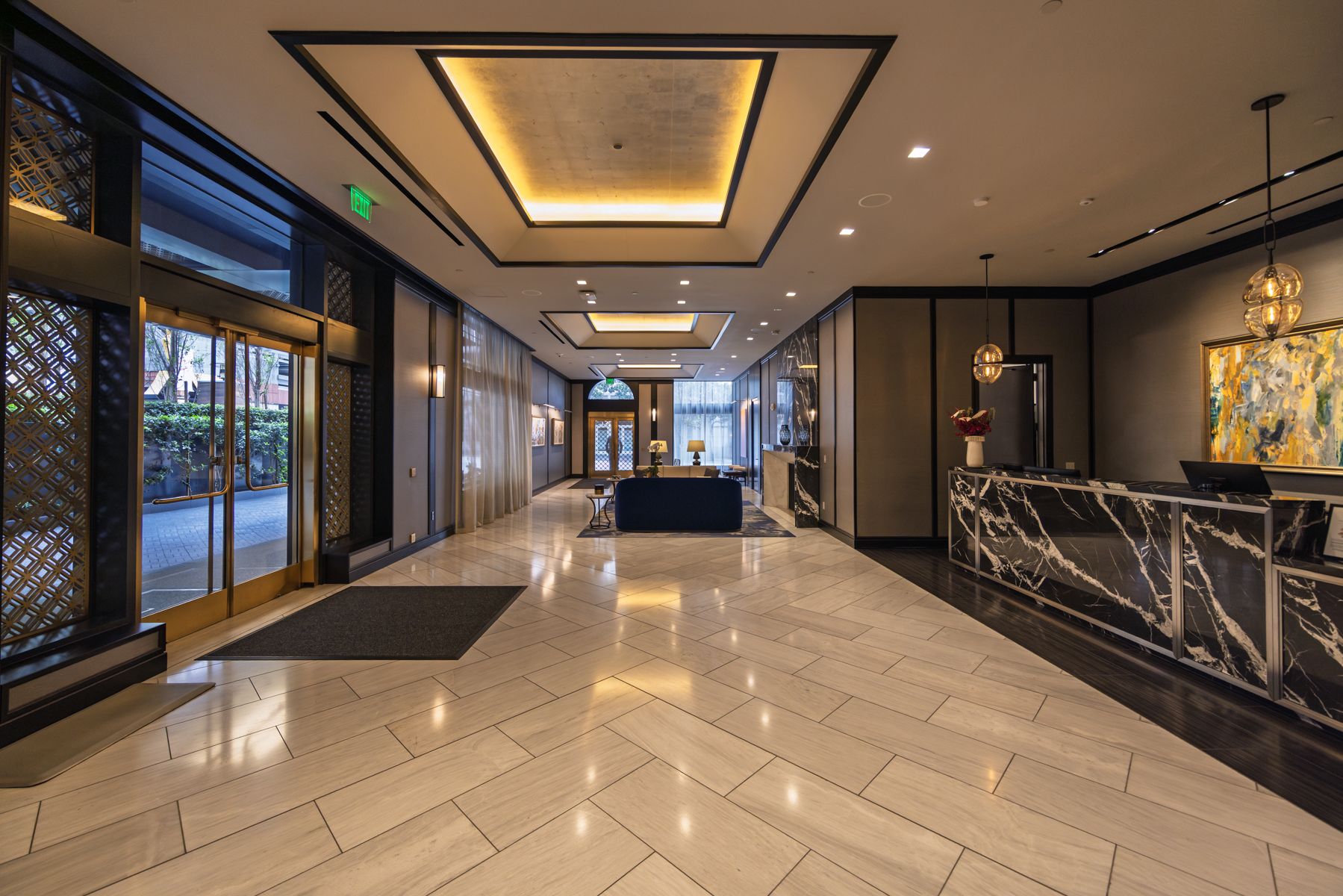 Attended residential lobby at 706 Mission with warm stone and millwork