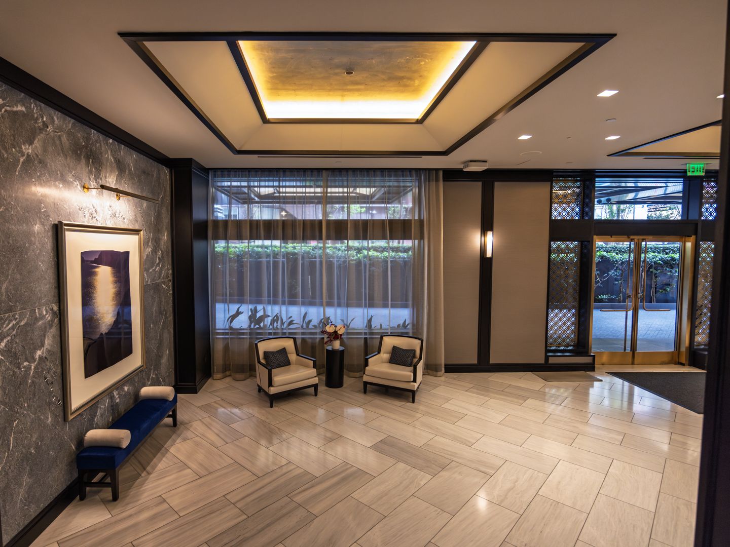 Attended residential lobby at 706 Mission with warm stone and millwork