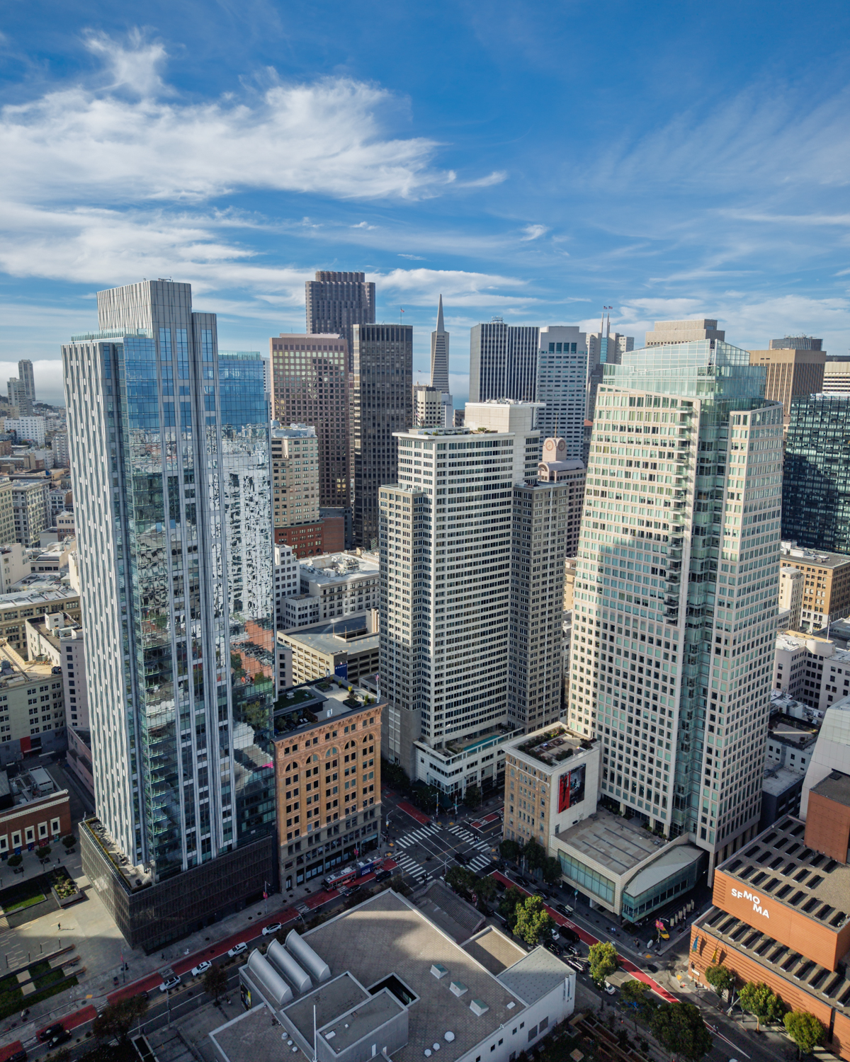 Daytime aerial view of the 706 Mission tower with the Transamerica Pyramid beyond