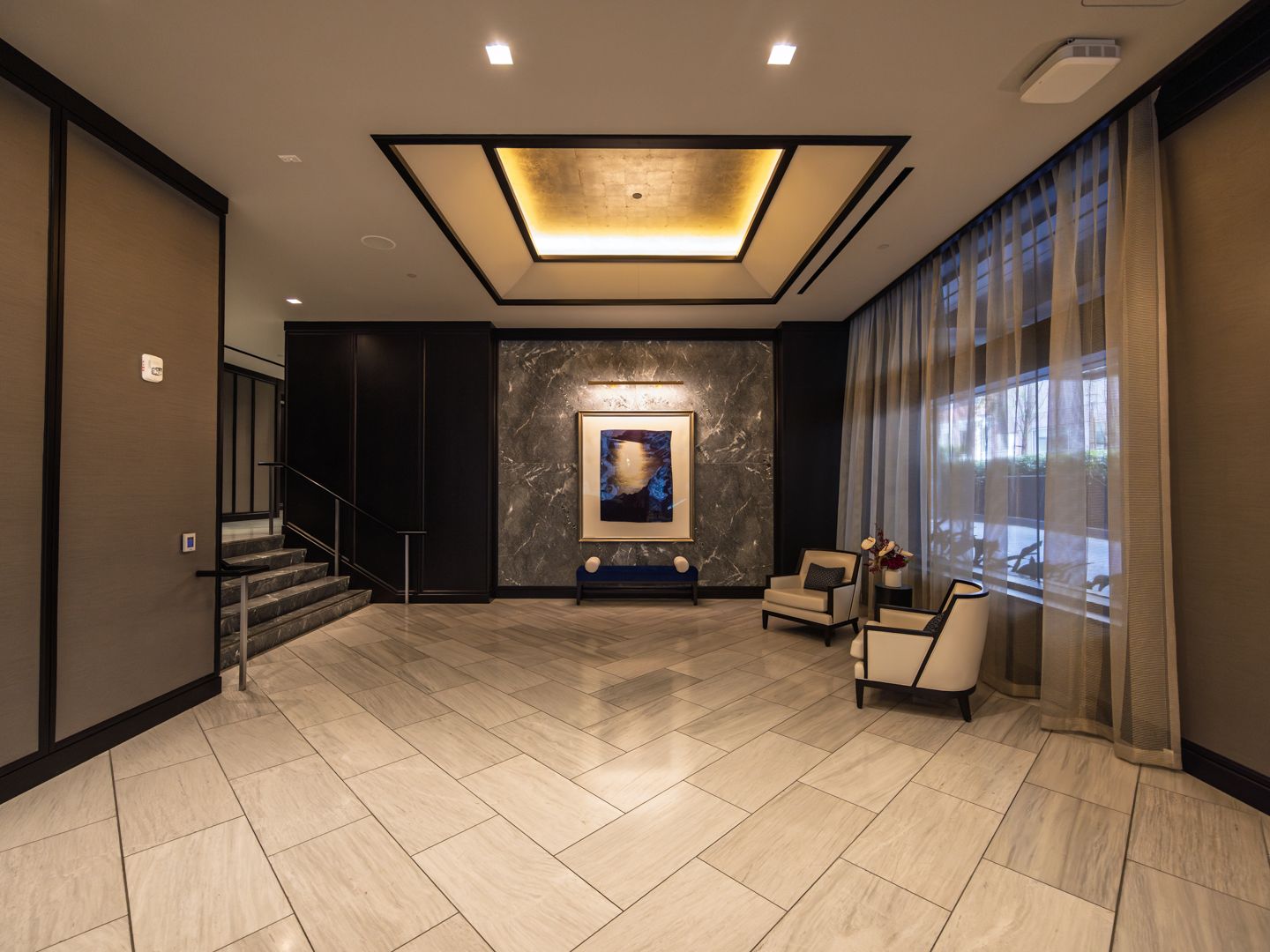 Attended residential lobby at 706 Mission with warm stone and millwork